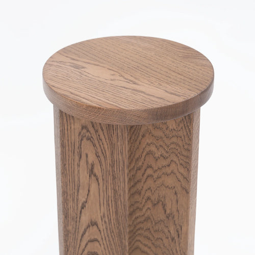 Affe pedestal in dark oak, featuring a minimalistic design and rich solid wood texture.