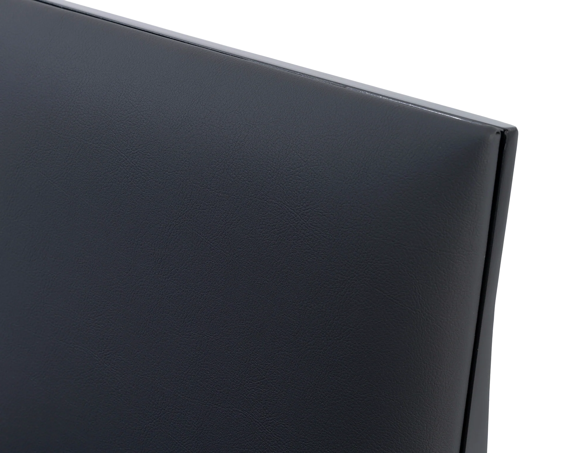 Detailed view of the Bella Dining Chair backrest from by Crea, upholstered in black vegan leather with subtle grain texture, framed in a sleek black steel edge for a clean and minimal silhouette.