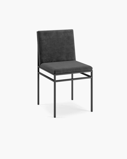 Bella dining chair in black velvet with minimalist design and sophisticated texture.