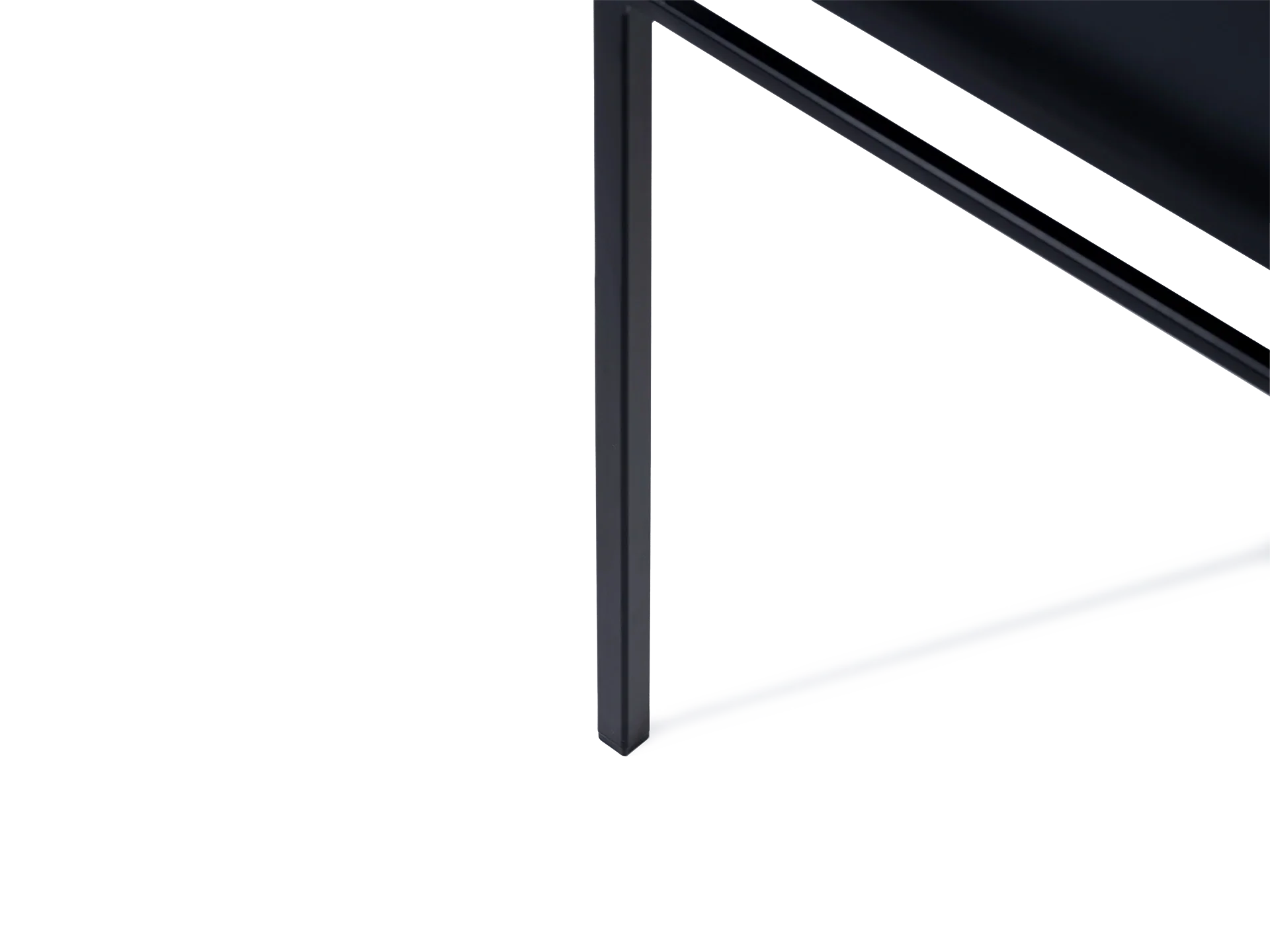 Close-up of the Bella Dining Chair leg by by Crea, showcasing its sleek black steel frame and integrated plastic foot glider designed to prevent floor scratches and ensure stability.