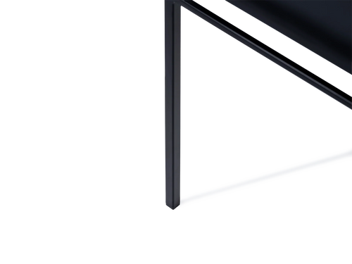 Close-up of the Bella Dining Chair leg by by Crea, showcasing its sleek black steel frame and integrated plastic foot glider designed to prevent floor scratches and ensure stability.