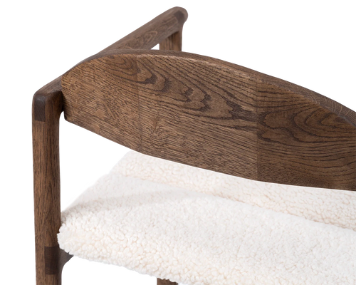 Rear view of Carl Bar Stool in dark oak with detailed joinery on the curved wooden backrest and ivory bouclé seat | by Crea.