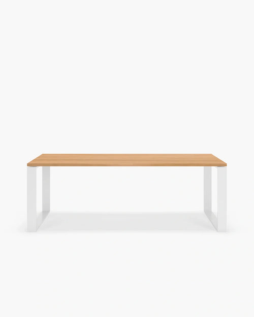 Diana dining table with elegant white frame and wooden top, designed for modern and fresh dining experiences.