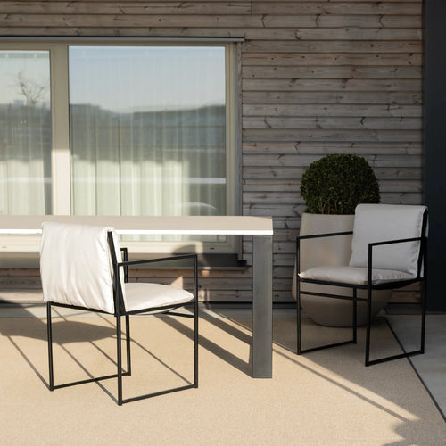 Elsy outdoor chair in black frame with marble acrylic, offering a sleek, modern aesthetic for outdoor spaces.