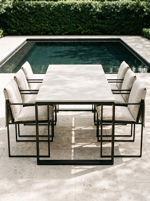 Garden Dining Chair Elsy with oat cushions around an outdoor dining table by a pool