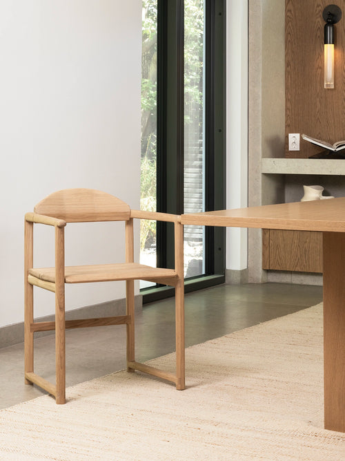 Dining Chair Erik - Oak Wood Frame beside a wooden dining table in a modern interior.