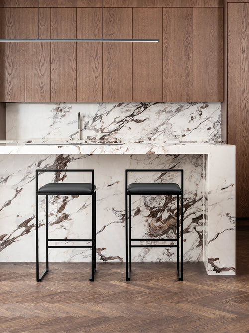 Bar Stool Freja with black frame and jade black leather cushion in modern kitchen setting.