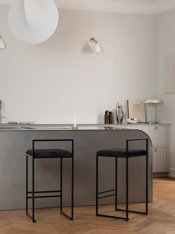 Bar Stool Freja in jade black velvet on a black steel frame in a modern kitchen