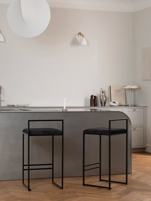 Bar Stool Freja in jade black velvet on a black steel frame in a modern kitchen