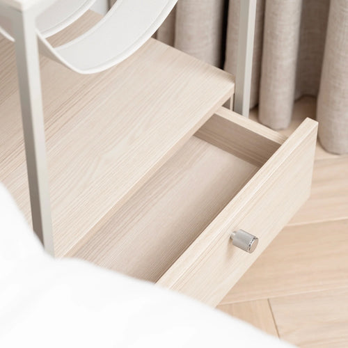 Close-up of Iris bed table drawer showcasing beige finish and sleek handle for stylish bedroom organization.