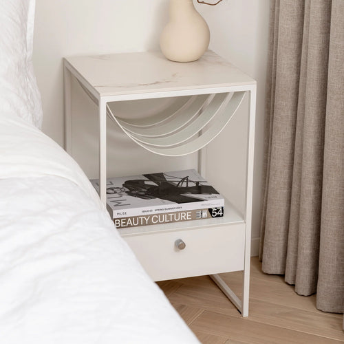 Iris bed table with white frame and Entzo dekton top, featuring modern design and storage drawer, ideal for contemporary bedrooms.