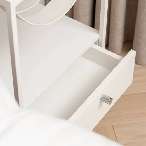 Close-up of white Iris bed table drawer showcasing sleek design and modern style, ideal for contemporary bedrooms.