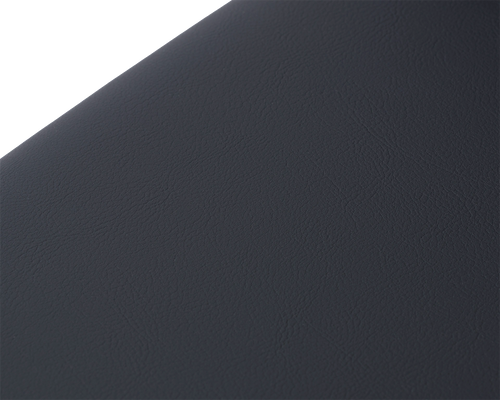 Macro detail of the Isabell Dining Chair seat cushion by Crea, showcasing the soft-grain texture of the black vegan leather upholstery for a minimalist Scandinavian finish.