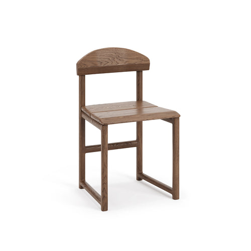 Front view of the Karin Dining Chair by Crea, crafted in solid dark oak with a sculpted seat and gently curved backrest, designed for a timeless Scandinavian dining space.