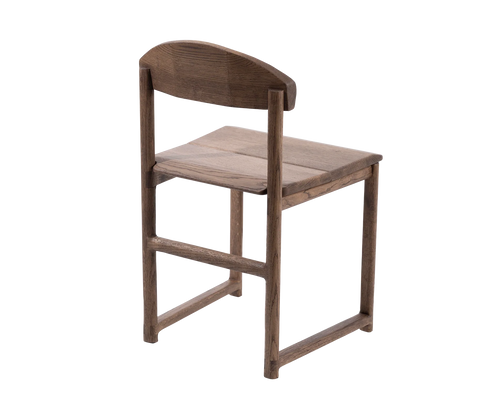 Rear view of the Karin Dining Chair in solid oak, showcasing curved backrest design and handcrafted joinery in Scandinavian style.