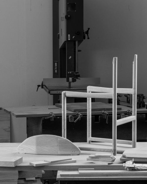 Handcrafted Karin Dining Chair frame and components in progress at by Crea’s factory. Solid oak structure shown mid-assembly, emphasizing Scandinavian design and meticulous woodworking techniques.