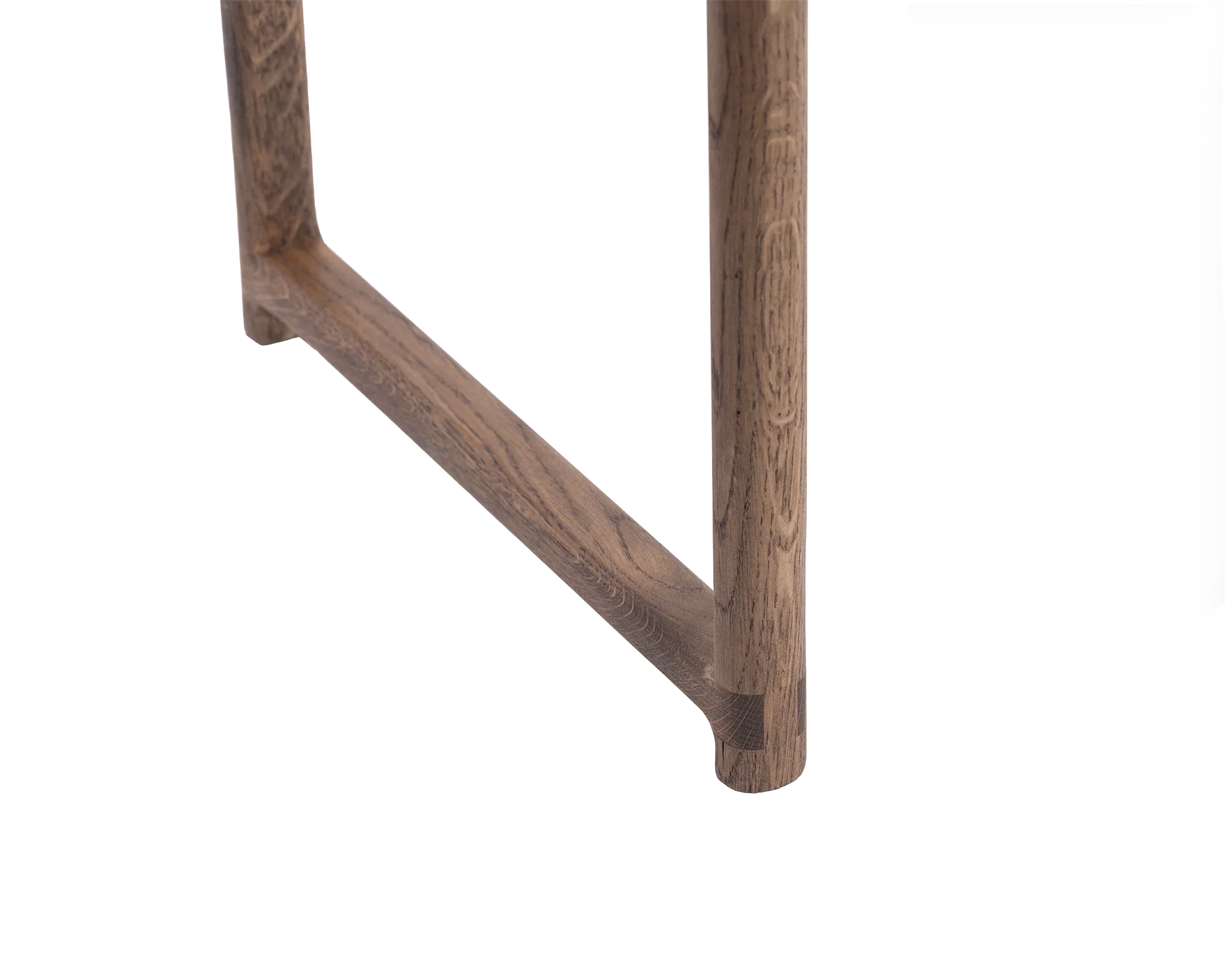 Close-up of the Karin Dining Chair leg in solid oak, highlighting rounded corner joinery and smooth wood grain in a Scandinavian minimalist design.