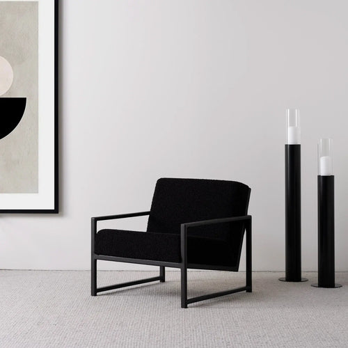 Armchair Einar in black oak frame and black bouclé cushion, minimalist design with modern styling.