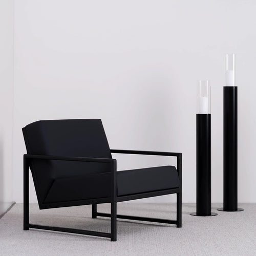 Black oak armchair with jade black leather seat, featuring sleek Scandinavian design and structured comfort.