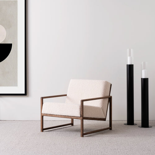 Dark oak armchair with ivory bouclé upholstery, offering Scandinavian comfort and style for cozy interiors.