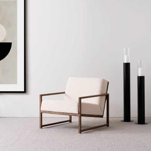 Armchair Einar featuring dark oak frame and ivory bouclé cushion, perfect for Scandinavian-style living spaces.