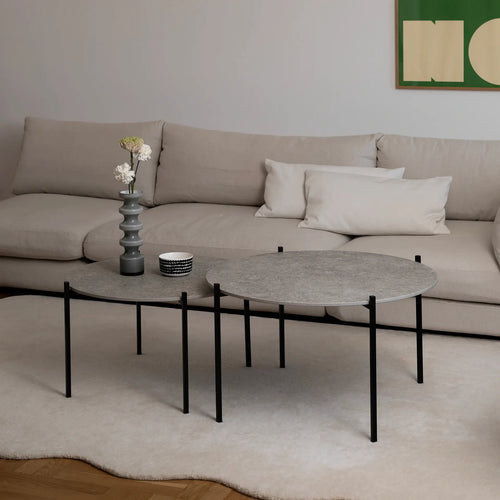 Leo Coffee Table 2-set by by Crea with Grigio Dekton tops and black steel frames, styled in a Scandinavian living room with ceramic vase, patterned bowl, and cream corner sofa. Handmade designer coffee tables for modern interiors.