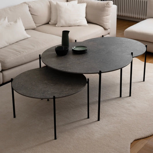 Leo Coffee Table 3-set by by Crea with Grafite Dekton tops and black steel frames, shown in a Scandinavian living room with a beige sectional and soft wool rug. Handmade modern coffee tables, perfect for contemporary interiors.