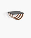 Lisa wall shelf in black oak with chocolate leather detail and sleek black frame, perfect for bold storage and wall art.
