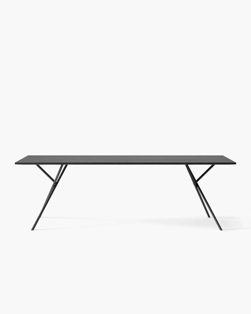 Melker dining table in sleek black oak design, featuring bold lines and a minimalist aesthetic for modern dining spaces.