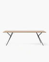 Melker dining table with a sleek wooden top and stylish black metal legs, perfect for elegant dining moments.