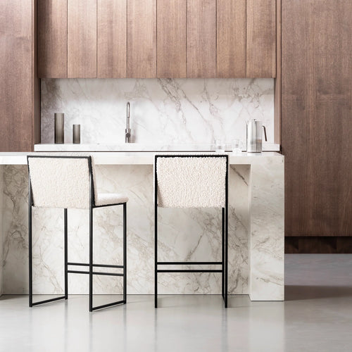 Philip Bar stool in black with ivory bouclé seat, showcasing modern design and high backrest, in a stylish kitchen setting.