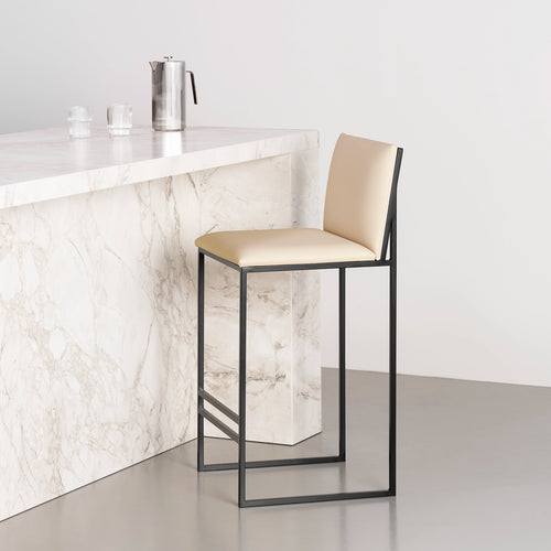Philip Bar stool with black frame and sand leather seat, ideal for modern minimalist interiors.