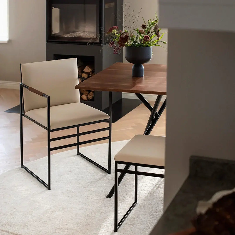Dining chair Sella in Latte vegan leather with contrasting Chocolate armrest covers.