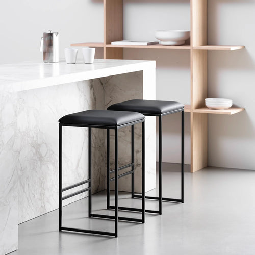 Svea bar stool in black with smooth leather seat, perfect for modern kitchen islands or high tables.
