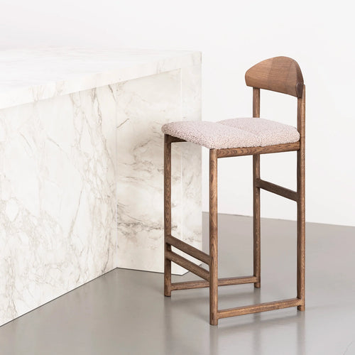 Dark oak Ted bar stool with greige bouclé seat, perfect for stylish dining spaces.