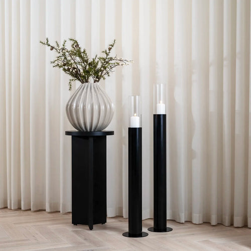 Scandinavian black floor candleholders with clear glass cylinders, perfect for home decor.