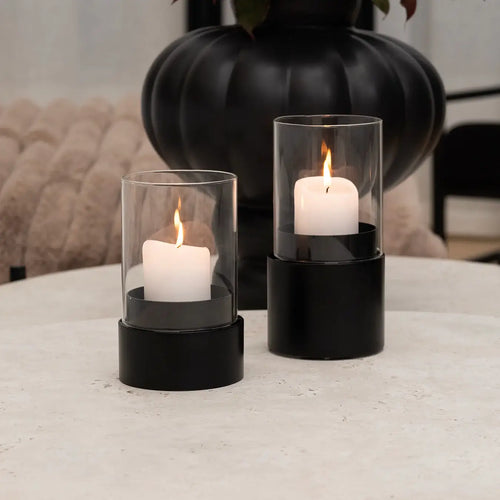 Candleholder Tom set of 2 with black frame and protective glass encasement showcasing a lit candle.