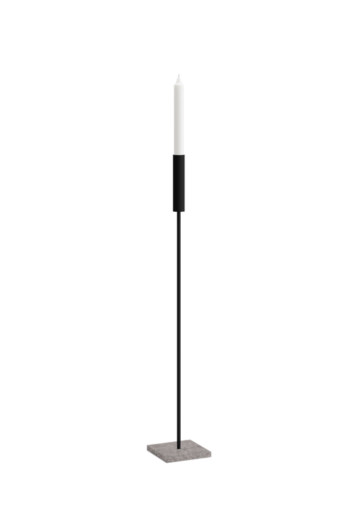 Front view of Vera candle holder in black frame with slim minimalist design and white taper candle, set on a square Caesarstone base.