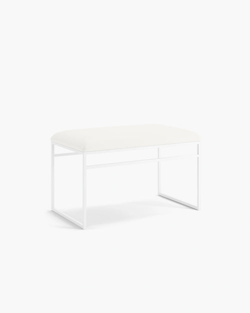 Wilma bench with white frame and cushion, featuring sleek Scandinavian design and minimalist aesthetic.