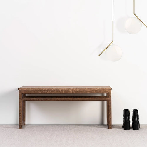 Wilma wood bench in dark oak finish, adding warmth to modern interiors with stylish pendant lights.