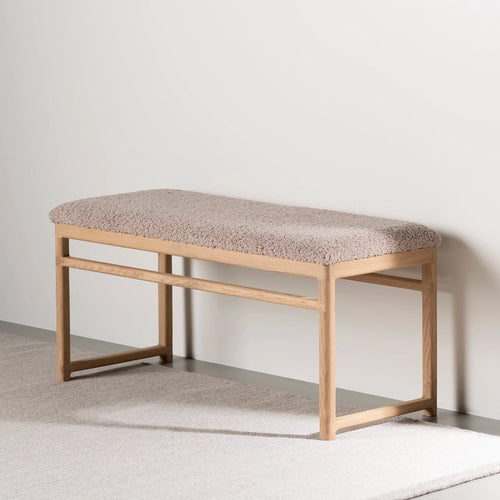 Wilma wood bench in warm oak and soft greige bouclé, perfect for entryways or bedrooms.