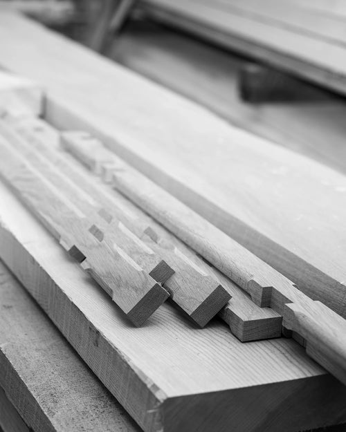 Precision-cut solid oak components for bar stools in production at by Crea’s factory. Showcasing Scandinavian craftsmanship and sustainable furniture manufacturing using FSC-certified wood.