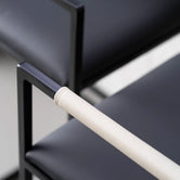 Arm and Backrest in Ivory vegan leather, fitted to a black steel by Crea chair