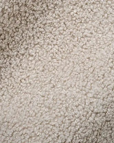 Close-up of ivory boucle, showing the looped texture of the woven pile
