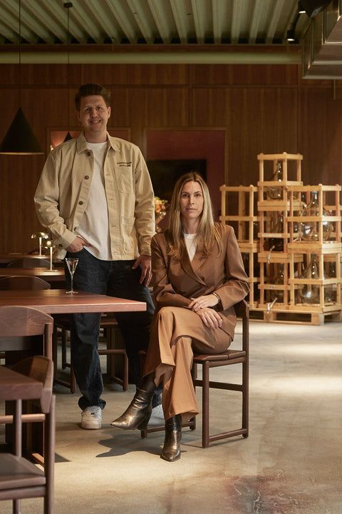 Alexandra Pettersson of by Crea and Dennis Bejedal of Norrbottens Destilleri photographed inside the distillery furnished with by Crea seating.