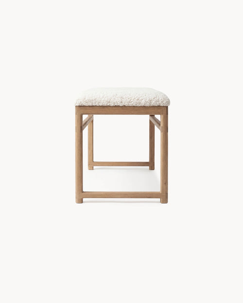 Oak Bench Alva featuring solid oak frame and ivory bouclé cushion, showcasing warmth and refined design.