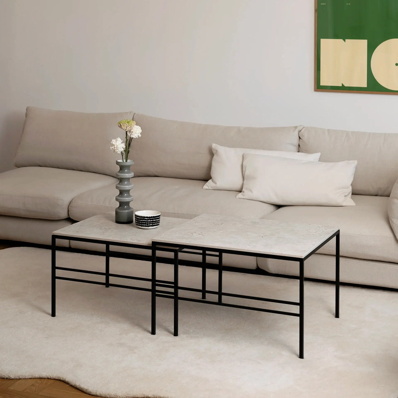 Anton Coffee Table 2-set by by Crea with Sabbia Dekton surfaces and a sleek black metal frame, styled in a Scandinavian living room with a beige sofa and soft ivory rug.