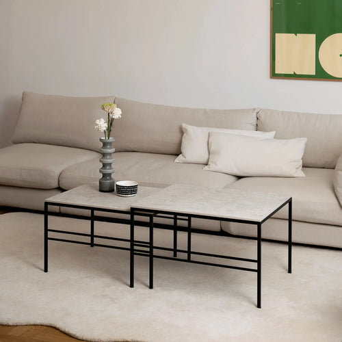 Anton Coffee Table 2-set by by Crea with Sabbia Dekton surfaces and a sleek black metal frame, styled in a Scandinavian living room with a beige sofa and soft ivory rug.