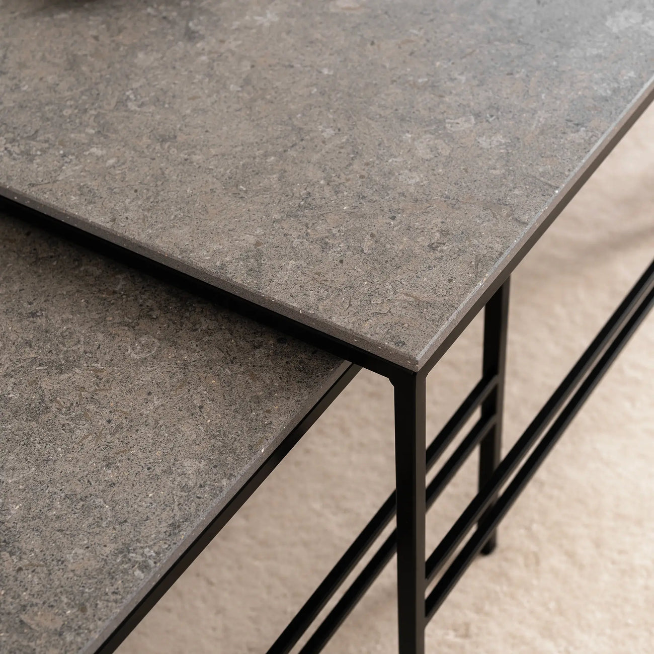 Close-up of the Anton Coffee Table by by Crea, featuring Grafite Dekton tops and a matte black steel frame. This rectangular nesting set combines handmade Scandinavian craftsmanship with durable, sustainable materials.