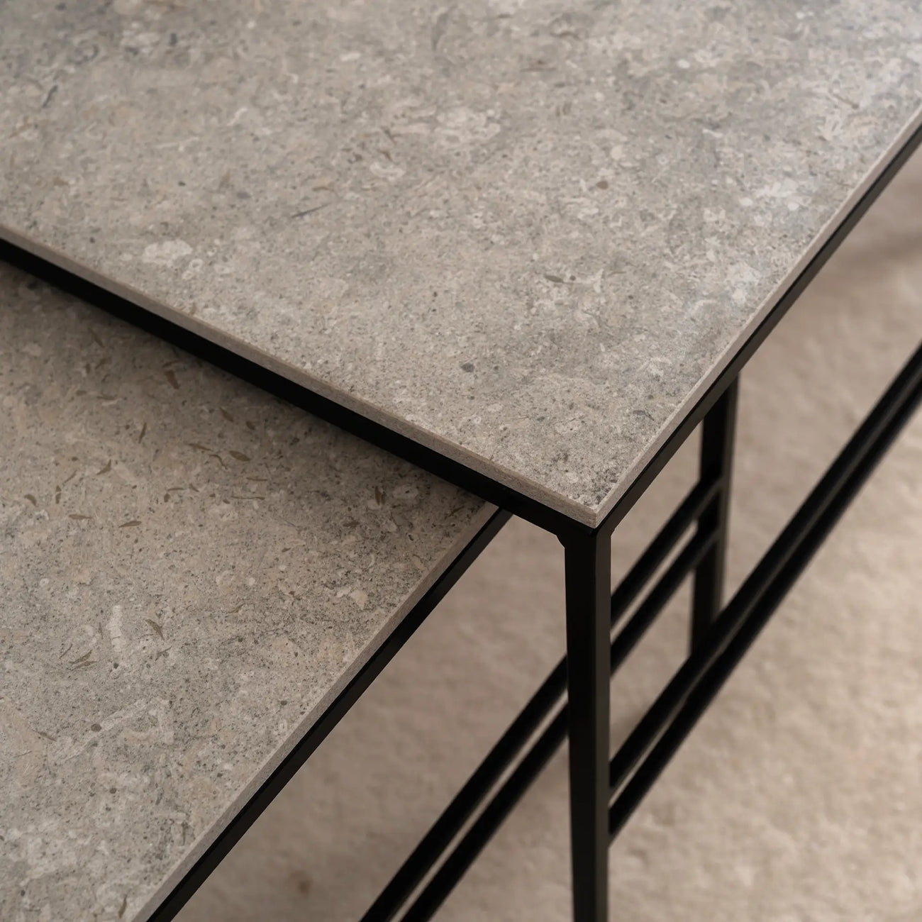 Close-up of Anton Coffee Table by by Crea featuring Grigio Dekton stone top and black steel frame. Showcases the refined edge detail and texture of the handmade, Scandinavian nesting table design.